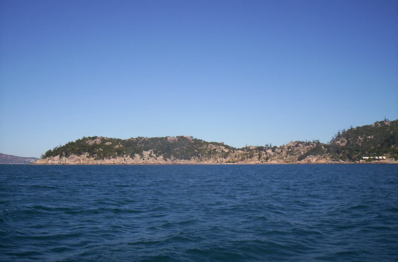 Magnetic Island is an island 8 kilometres (5 mi) offshore from the city of Townsville]], Queensland, Australia. This 52 km2 (20.1 sq mi) mountainous island in Cleveland Bay has effectively become a suburb of Townsville, with 2,335 permanent residents.