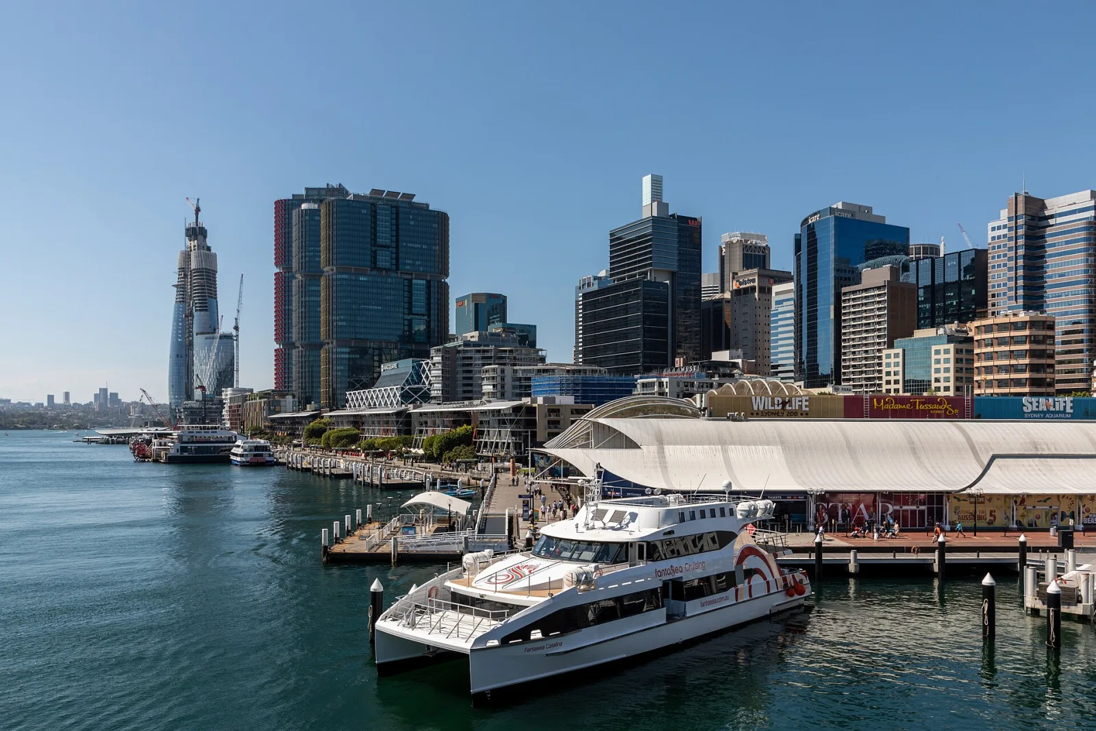 King Street Wharf at Darling Harbour, Sydney, New South Wales, AustraliaDarling Harbour in Sydney is located on the eastern edge of the city center and has a long and varied history. Originally, the area was a natural bay and river connection used by the Gadigal and Eora communities. In the 19th century, the harbour developed into an important hub for goods, shipping, and naval activities, with customs facilities, shipyards, and warehouses dominating the landscape. Through land reclamation and redevelopment, Darling Harbour gradually transformed from a working port to a leisure, recreation, and exhibition district.In the 1980s, a strategic shift took place: urban redevelopment, new infrastructure, and major events led to increased use as an urban leisure and MICE location. With the Bicentennial in 1988, the area was redesigned, and museums, convention centers, restaurants, and green spaces were created. Today, Darling Harbour combines history with science, culture, and leisure and remains a vibrant attraction in the heart of Sydney.